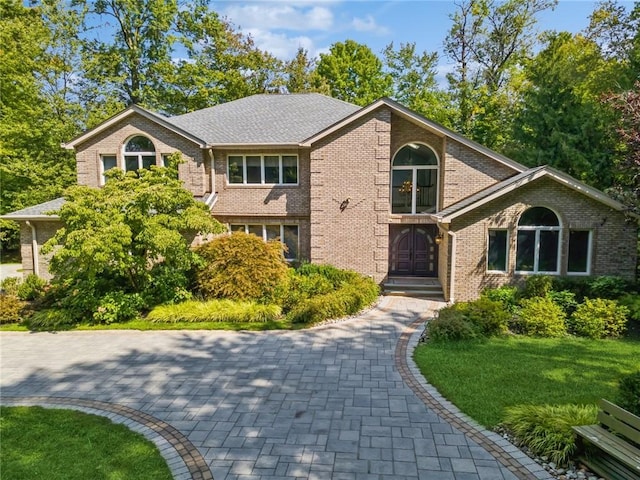 view of property featuring a front lawn