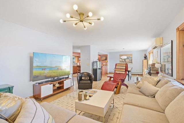 living room with a chandelier, a wall unit AC, and light wood-style floors