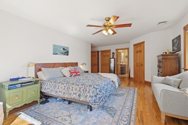 bedroom with light wood-type flooring, visible vents, and a ceiling fan