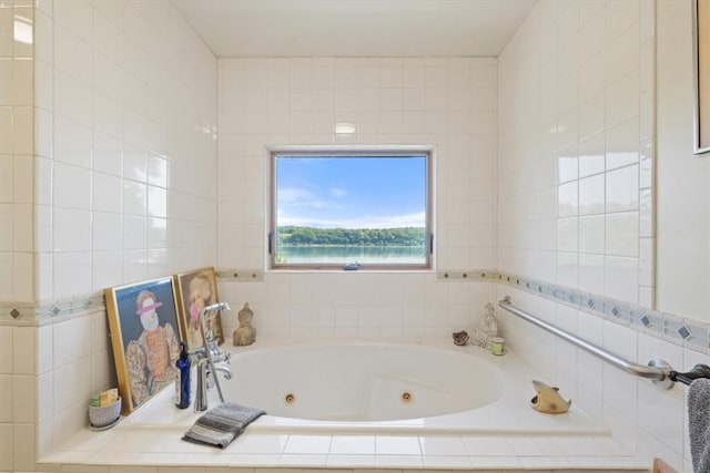 full bathroom featuring tile walls and a jetted tub