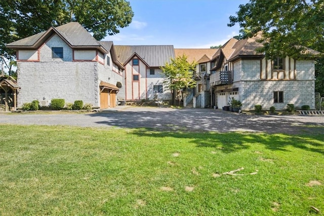 view of front of property with stone siding, a residential view, and a front lawn