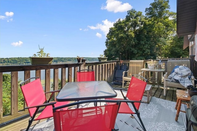 wooden terrace featuring outdoor dining area