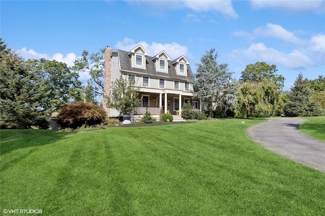 view of front of home featuring a porch and a front lawn