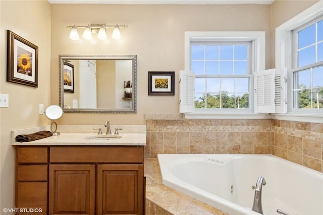 bathroom featuring vanity and tiled bath