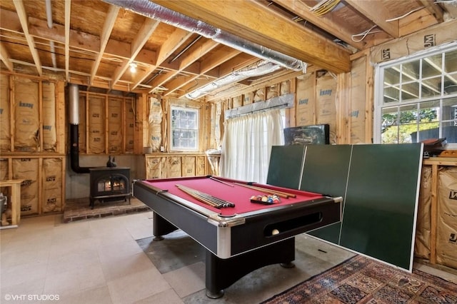 game room with a wood stove and billiards