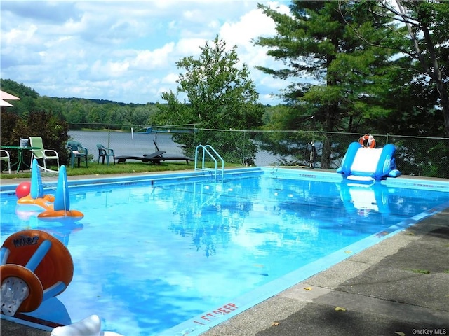 view of pool with a water view