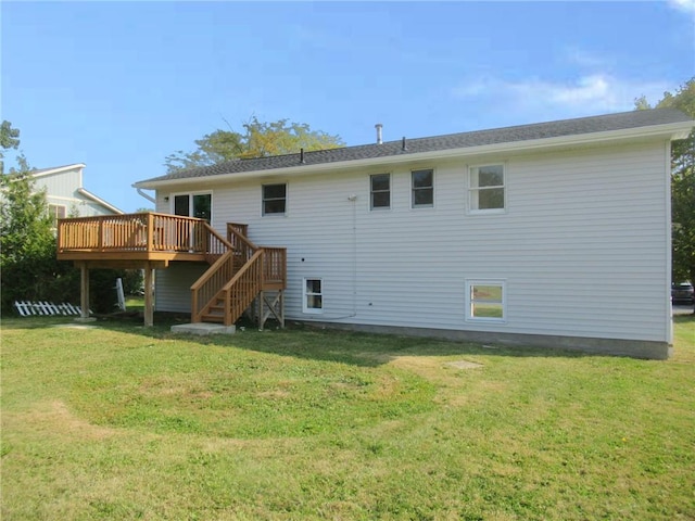 back of property featuring a deck and a lawn