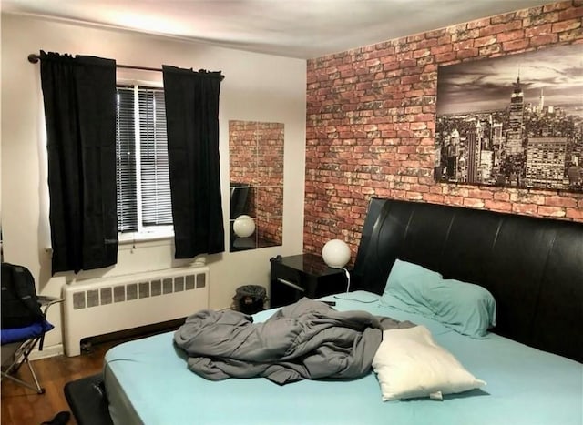 668 E 236th St, Bronx, NY 10466 - bedroom with radiator, wood finished floors, and brick wall