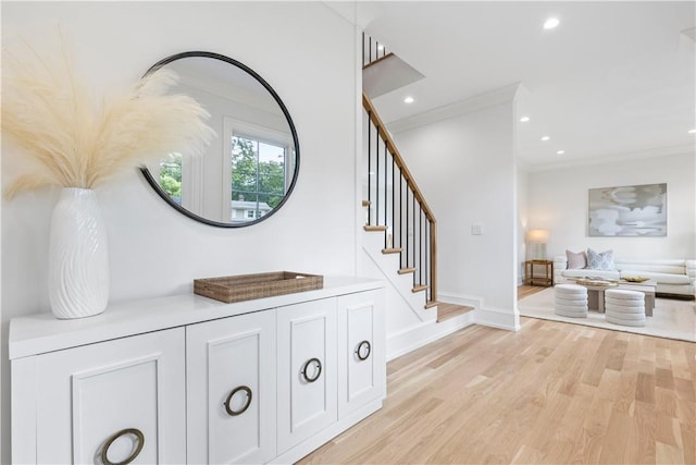 interior space with light hardwood / wood-style floors and crown molding