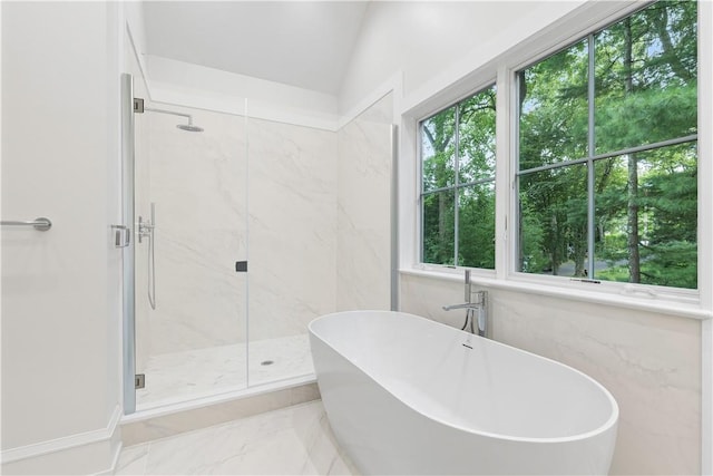 bathroom with plus walk in shower, vaulted ceiling, and a wealth of natural light