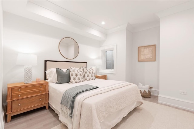 bedroom with crown molding and light hardwood / wood-style flooring