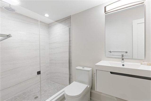 bathroom with vanity, a shower with shower door, and toilet