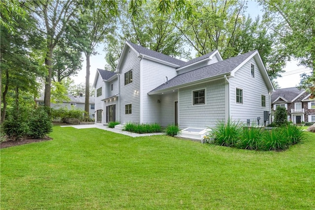 back of house with a lawn