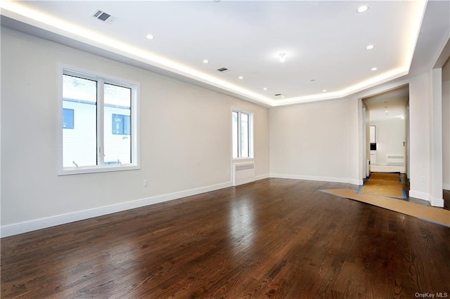 unfurnished room featuring dark hardwood / wood-style floors