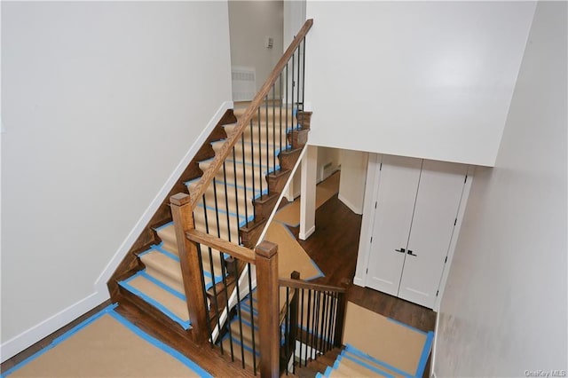 staircase with hardwood / wood-style floors