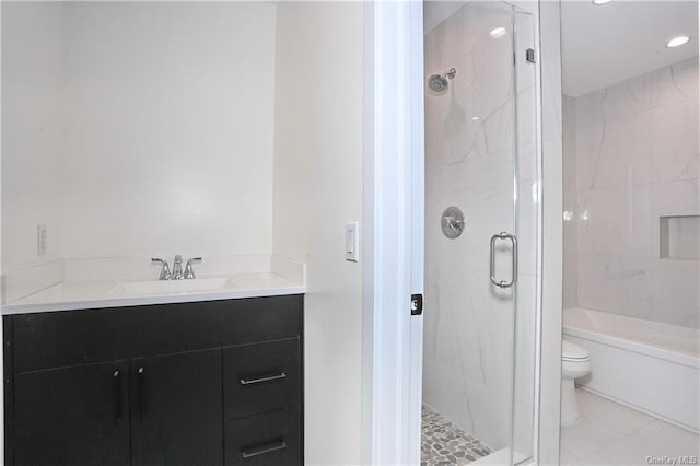 bathroom featuring tile patterned flooring, toilet, an enclosed shower, and vanity