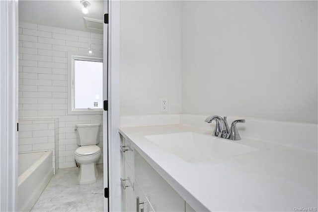 bathroom with vanity, toilet, and tile walls