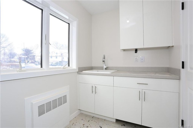 interior space featuring vanity and radiator