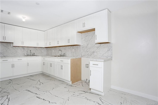 kitchen with white cabinetry and sink