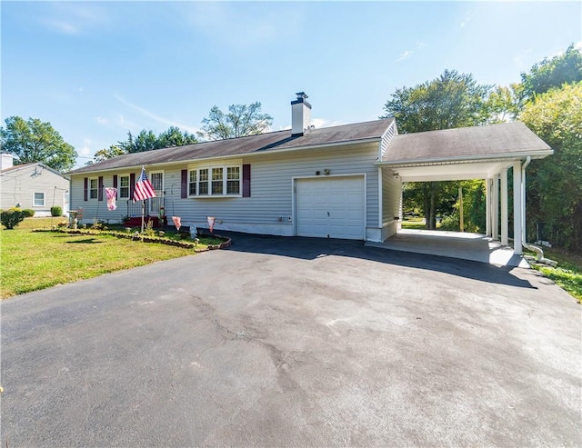 single story home featuring a carport, a garage, and a front lawn