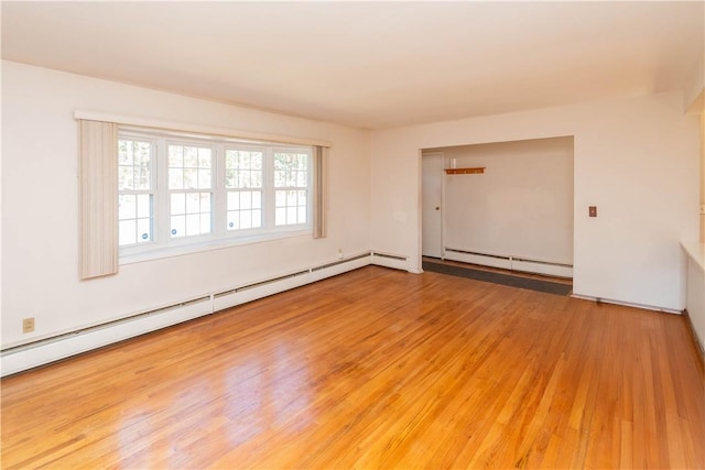 unfurnished room with wood-type flooring and a baseboard radiator