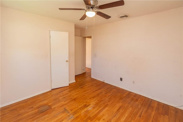 empty room featuring ceiling fan and light wood-type flooring