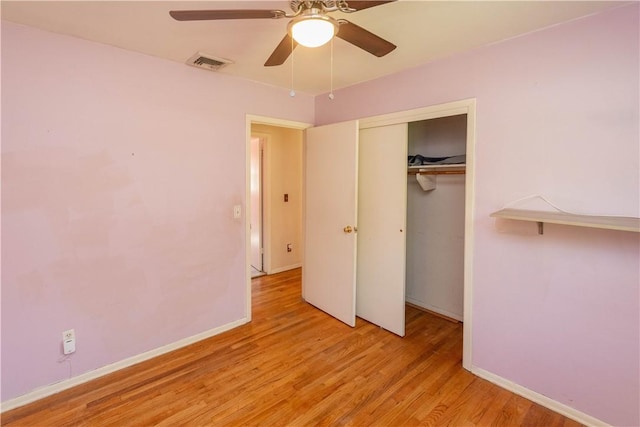 unfurnished bedroom with a closet, light hardwood / wood-style floors, and ceiling fan