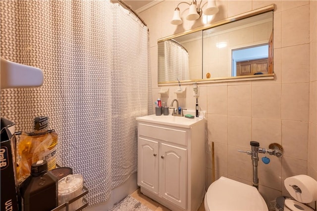 bathroom featuring vanity, toilet, tile walls, and crown molding