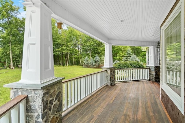 wooden terrace with a lawn