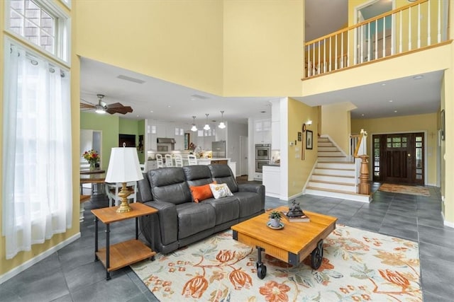 living room featuring plenty of natural light and a towering ceiling