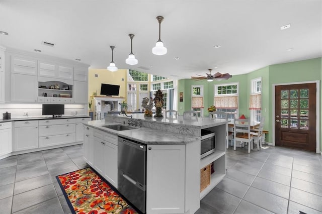 kitchen featuring white cabinetry, sink, a kitchen island with sink, and pendant lighting