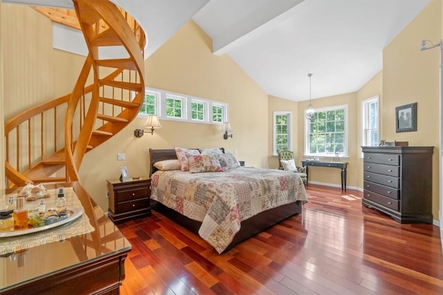 bedroom featuring dark hardwood / wood-style floors and vaulted ceiling with beams