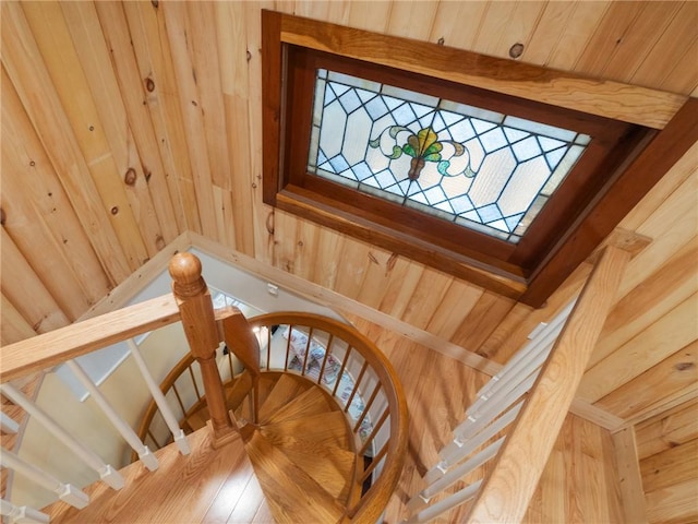 staircase featuring wooden walls