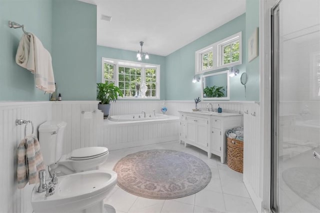 full bathroom with tile patterned floors, toilet, a bidet, vanity, and independent shower and bath