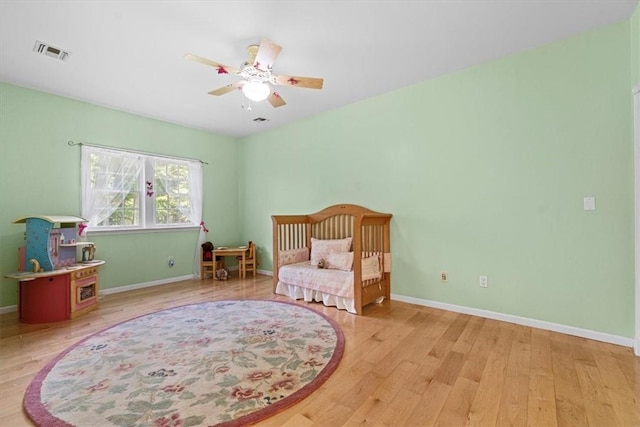 bedroom with light wood-type flooring and ceiling fan