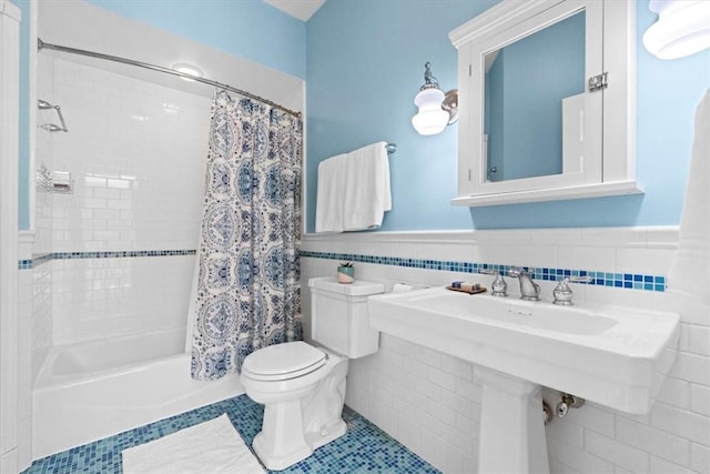 bathroom featuring tile walls, shower / tub combo with curtain, tile patterned floors, and toilet