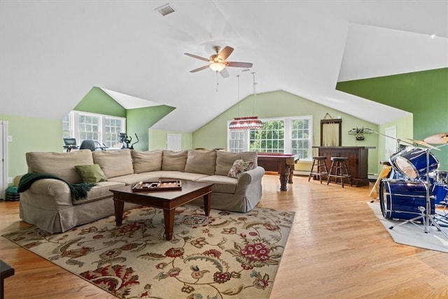 living room featuring lofted ceiling, light hardwood / wood-style floors, and ceiling fan