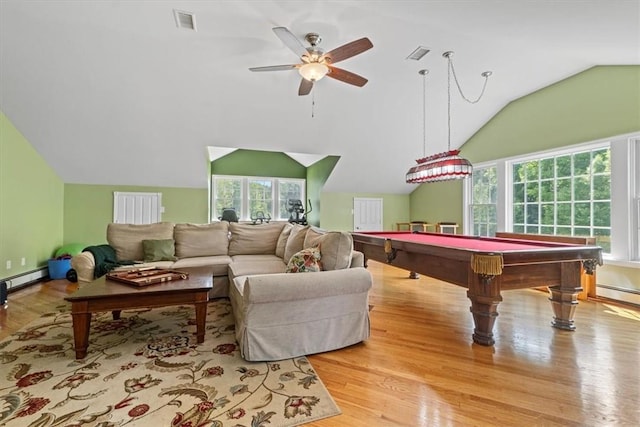 rec room with lofted ceiling, a wealth of natural light, baseboard heating, and light wood-type flooring