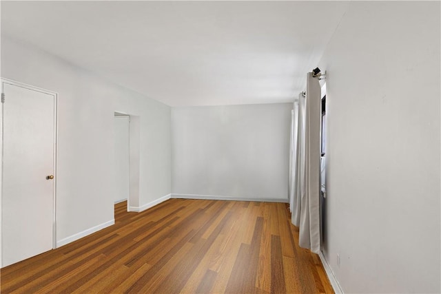 unfurnished room featuring hardwood / wood-style flooring