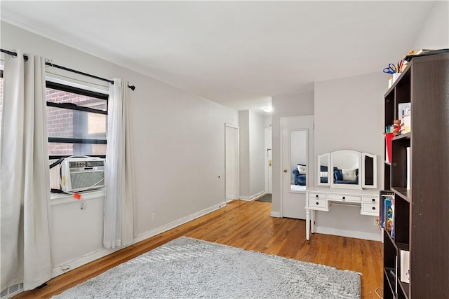 interior space with light hardwood / wood-style floors and cooling unit