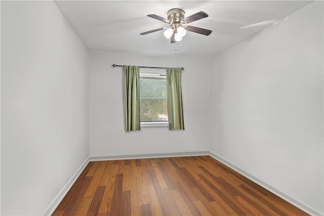 spare room with ceiling fan and dark wood-type flooring