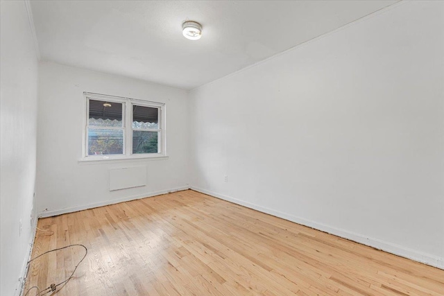 unfurnished room with wood-type flooring