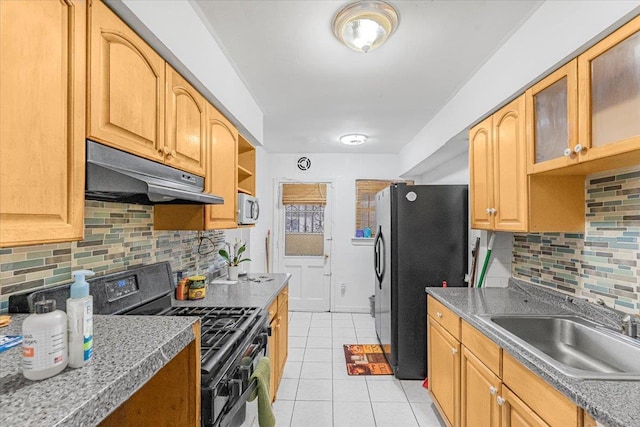 kitchen with decorative backsplash, light tile patterned floors, sink, and black appliances