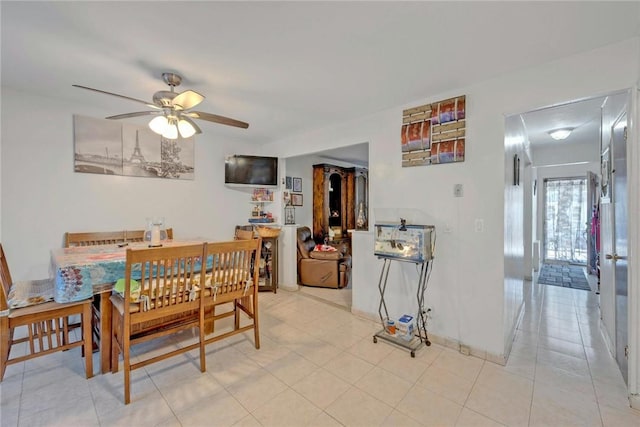 tiled dining room with ceiling fan