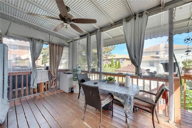 sunroom / solarium with ceiling fan and a healthy amount of sunlight