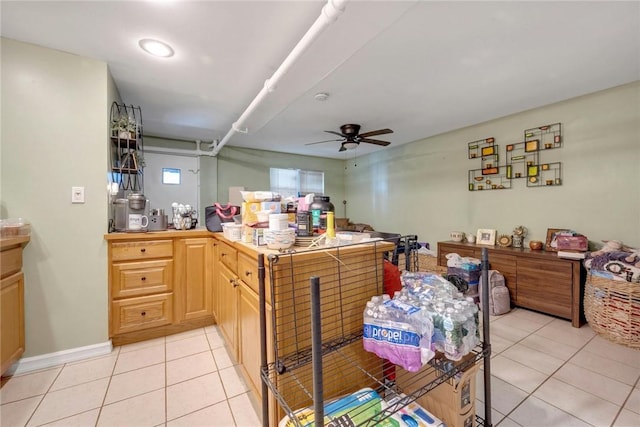 kitchen with light tile patterned floors, ceiling fan, and light brown cabinetry