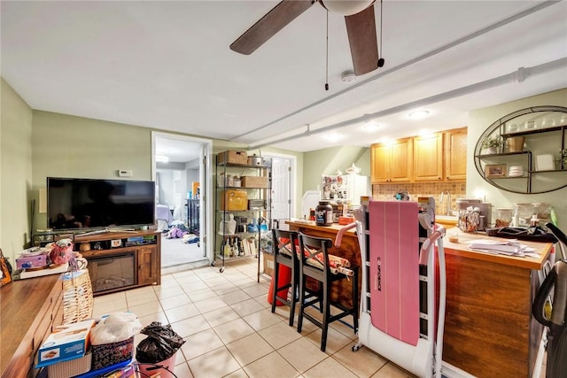 kitchen featuring decorative backsplash, ceiling fan, and light tile patterned flooring