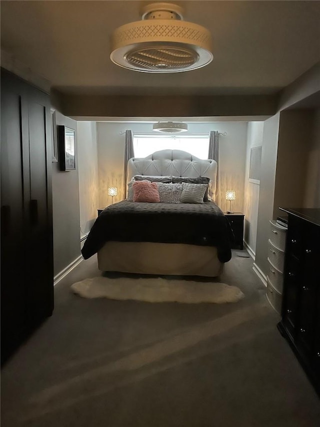 bedroom featuring dark carpet