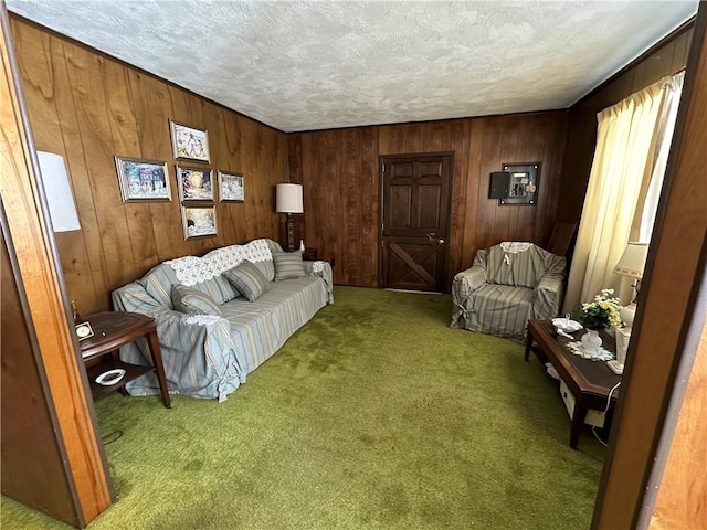 carpeted living room with wood walls and a textured ceiling