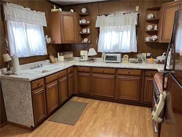 kitchen with plenty of natural light, wood walls, and sink